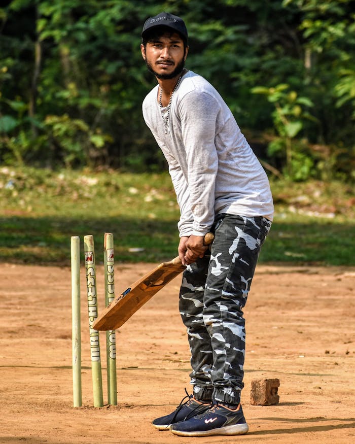 Man Holding Cricket Bat 